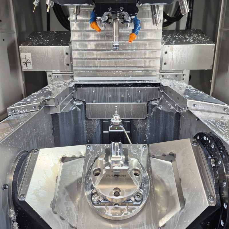 Inside a 5-axis CNC mill with workpiece on the rotary table