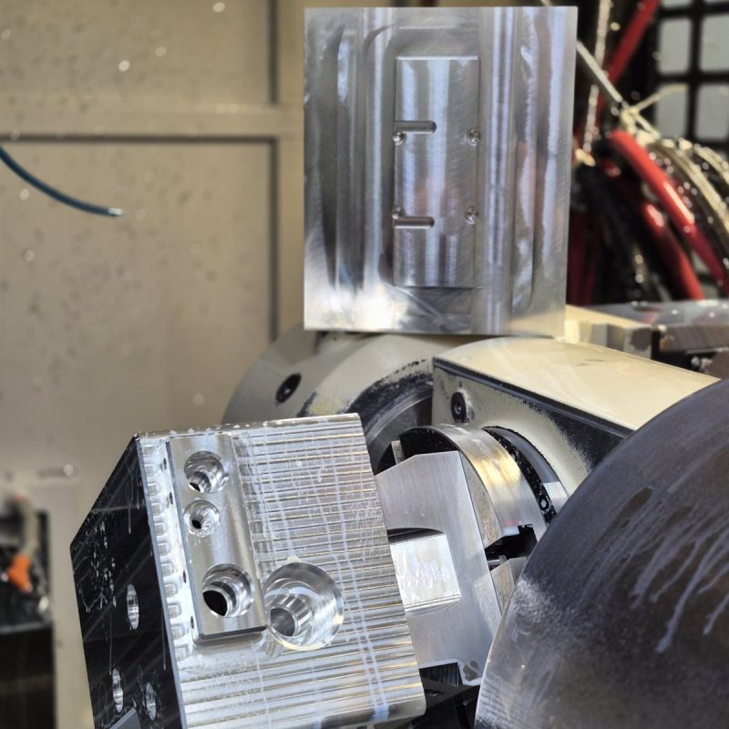 Aluminum parts mid-machining inside a 5-axis mill