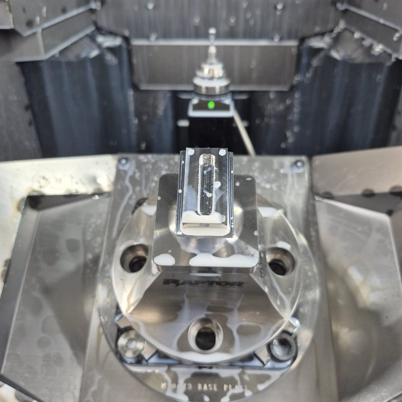 Raptor workholding fixture inside a 5-axis mill with probe