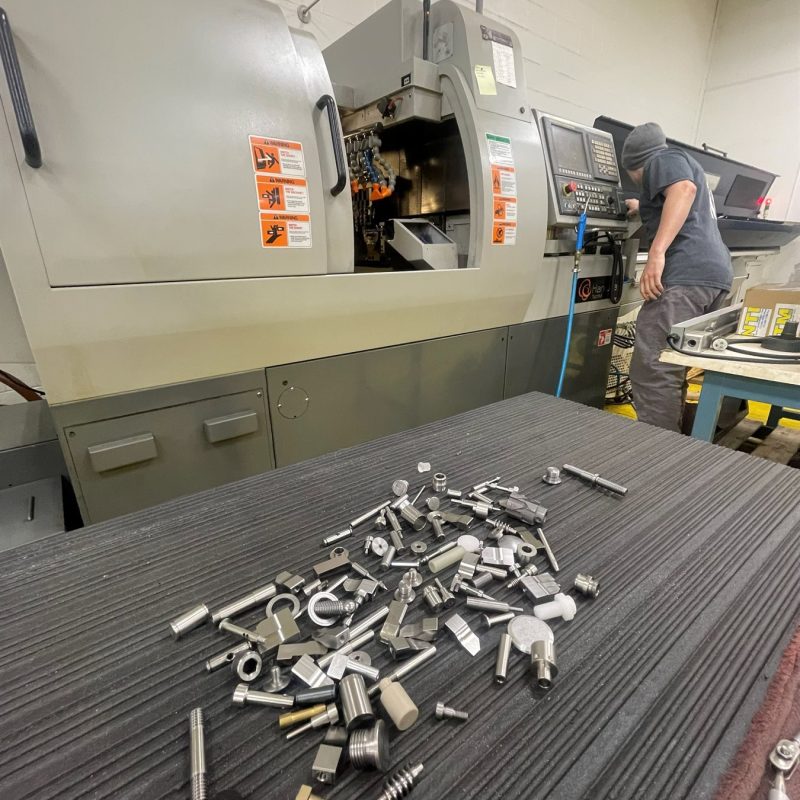 NTM shop floor with an operator at a Hanwha Swiss Screw machine